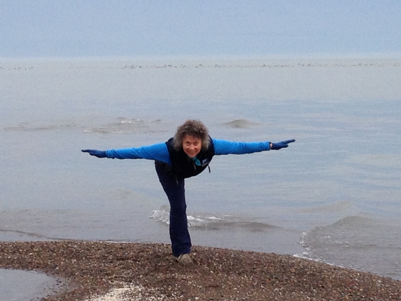 Jenny in Warrior Three Pose (Virabhadrasana III) at the very tip of Point Pelee on Lake Erie, the southernmost part of mainland Canada, Point Pelee National Park, Ontario (Photo by Ian Hatter).