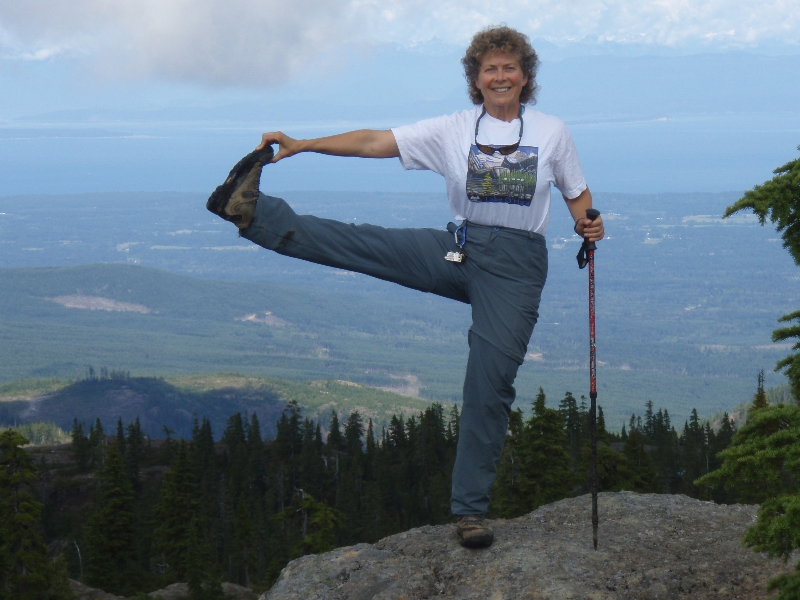 A closer view of Jenny in Standing Extended Hand to Big Toe Pose (Utthita Hasta Padangustasana) with a little help from a hiking pole on Mt Beecher, Strathcona Provincial Park, Vancouver Island, B.C. (Photo by Ian Hatter).