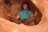 Note that as Jenny meditates in Easy Pose (Sukasana), each of her thumbs touches the index finger on each hand.  This is known as Gyan or Chin Mudra, a hand position reputed to instill wisdom and calm, Valley of Fire State Park, Nevada (Photo by Ian Hatter).