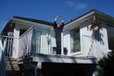 Ian Hatter in Mountain Pose with arms extended overhead, palms together (Utthita Hasta in Tadasana) at home on the deck, Victoria, B.C. (Photo by Jenny Feick).