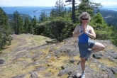 Jenny in Tree Pose (Vrikshasana) hands in prayer position (Anjali Mudra), on top of the South Peak of the Chinese Mountains on Quadra Island, B.C.(Photo by Ian Hatter).