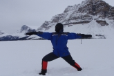 Jenny in Warrior Two Pose (Virabhadrasana II) on a snow and ice covered Bow Lake, headwaters of the Bow River, Banff National Park.  It was minus 27 degrees Celcius when this picture was taken, proving a dedicated yogi can still do outdoor yoga even during a Canadian winter (Photo by Ian Hatter).