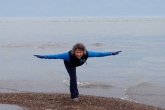 Jenny in Warrior Three Pose (Virabhadrasana III) at the very tip of Point Pelee on Lake Erie, the southernmost part of mainland Canada, Point Pelee National Park, Ontario (Photo by Ian Hatter).